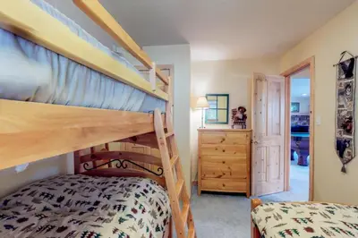 a bedroom with a bunk bed and a staircase at Lakeview Luxury Getaway in South Lake Tahoe