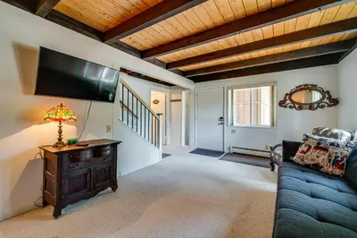 a living room with a couch and a flat screen tv at Walk to Lake Tahoe Family Retreat with Deck! in Incline Village