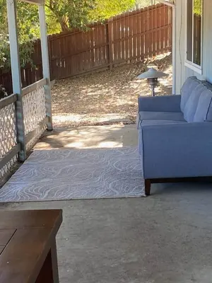 a blue couch sitting on a porch with a rug at Kipps Hill Haven A - Folsom Lake Escape in El Dorado Hills