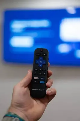 a hand holding a remote control in front of a tv at Kipps Hill Haven B — Folsom Lake Escape in El Dorado Hills