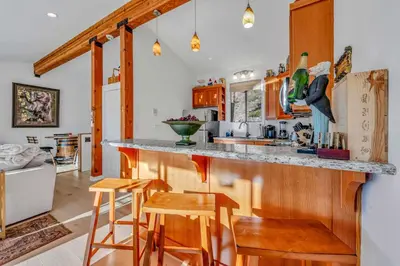 a kitchen with a counter and some stools at Incline Village Views - Pellet Stove Deck in Incline Village