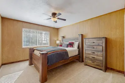 a bedroom with a bed and a ceiling fan at Lakeside Ski House in Carnelian Bay