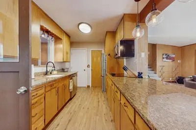 a large kitchen with wooden cabinets and a counter top at Lakeside Ski House in Carnelian Bay