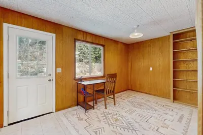 an empty room with a desk and a window at Lakeside Ski House in Carnelian Bay
