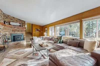 a living room with a couch and a fireplace at Lakeside Ski House in Carnelian Bay