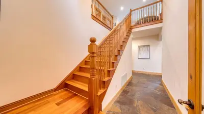 a staircase in a home with wooden treads at 2 Truckee Cabin • Sleeps 20 • Hot tub • Games • Near Donner Lake Donner Ridge Alplenglow Chalet by AvantStay in Truckee