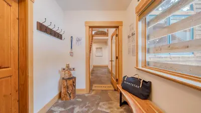 a hallway with a bench and a window at 2 Truckee Cabin • Sleeps 20 • Hot tub • Games • Near Donner Lake Donner Ridge Alplenglow Chalet by AvantStay in Truckee