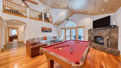 a living room with a pool table and a fireplace at 2 Truckee Cabin • Sleeps 20 • Hot tub • Games • Near Donner Lake Donner Ridge Alplenglow Chalet by AvantStay in Truckee