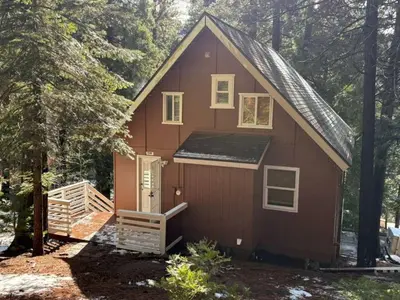 a red tiny house in the woods at El Capitan Hideaway - A-Frame Cabin Yosemite West in Yosemite West