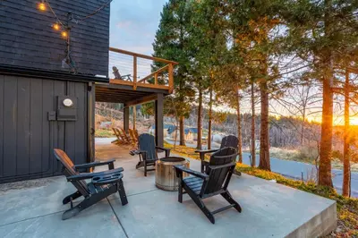 a group of chairs sitting on a patio at Dogwood Retreat- Family friendly Epic Views in Shaver Lake