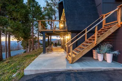 a house with a staircase on the side of it at Dogwood Retreat- Family friendly Epic Views in Shaver Lake