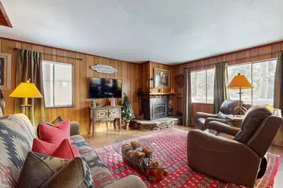 a living room with a couch and a tv at Cabin on the Green in South Lake Tahoe