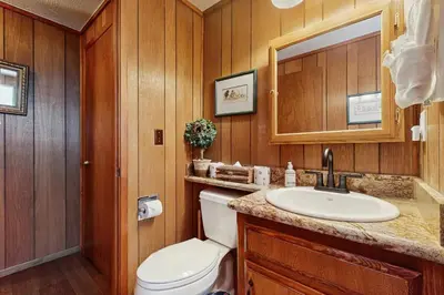 a bathroom with a toilet and a sink at Cabin on the Green in South Lake Tahoe