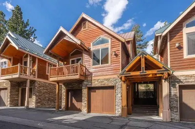 a large wooden house with a garage at Mammoth Gateway Village #3 in Mammoth Lakes