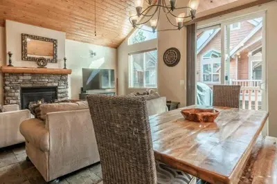 a living room with a wooden table and a couch at Mammoth Gateway Village #3 in Mammoth Lakes