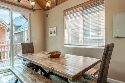 a dining room with a wooden table and chairs at Mammoth Gateway Village #3 in Mammoth Lakes