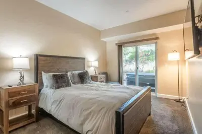 a bedroom with a large bed and a window at Mammoth Gateway Village #3 in Mammoth Lakes
