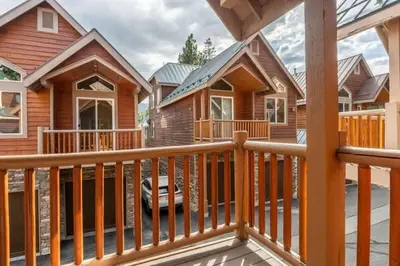 a home with a wooden railing and a balcony at Mammoth Gateway Village #3 in Mammoth Lakes