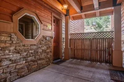 an empty porch of a house with a brick wall at Mammoth Gateway Village #3 in Mammoth Lakes