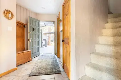 a hallway with stairs and a blue door at Sierra Park Villas 28 in Mammoth Lakes