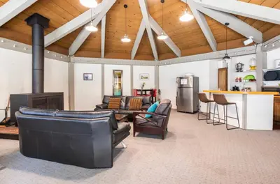 a living room with couches and a kitchen and a bar at Sierra Park Villas 28 in Mammoth Lakes