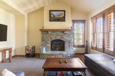 a living room with a fireplace and a couch at Lodges 1123 in Mammoth Lakes