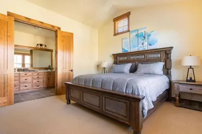 a bedroom with a large bed and a large mirror at Lodges 1123 in Mammoth Lakes