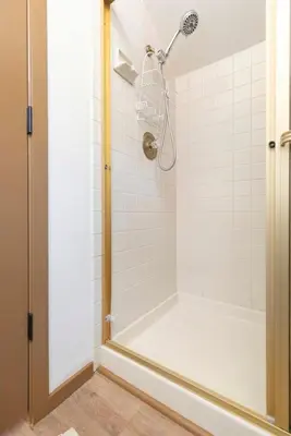 a bathroom with a shower with white tiles at Winterset 4 in Mammoth Lakes