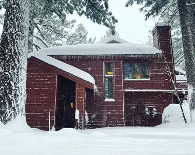 a small red brick house with snow on it at Winterset 4 in Mammoth Lakes