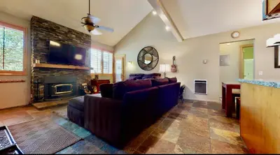 a living room with a couch and a fireplace at San Sierra 24 in Mammoth Lakes
