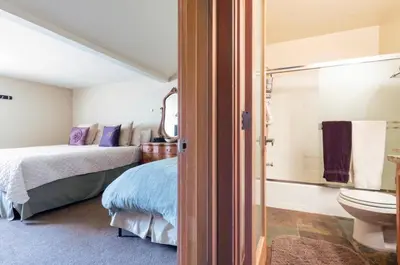 a bedroom with a bed and a bathroom with a toilet at San Sierra 24 in Mammoth Lakes