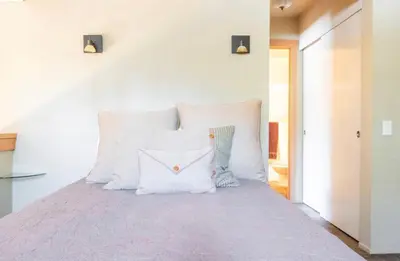 a bedroom with a large bed with white pillows at San Sierra 24 in Mammoth Lakes