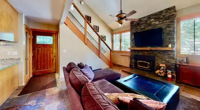a living room with a couch and a fireplace at San Sierra 24 in Mammoth Lakes