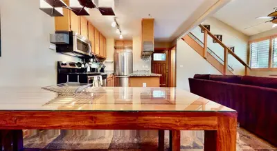 a kitchen with a wooden table in a room at San Sierra 24 in Mammoth Lakes