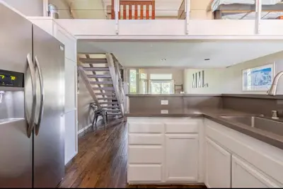 a kitchen with a stainless steel refrigerator and a staircase at Snowcreek 569 in Mammoth Lakes