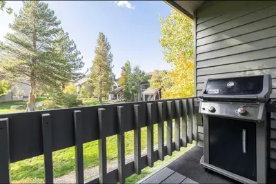 a grill on the side of a house next to a fence at Snowcreek 569 in Mammoth Lakes