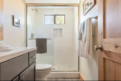 a bathroom with a shower with a toilet and a sink at Mammoth Sierra Townhome 1 in Mammoth Lakes