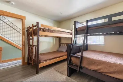 two bunk beds in a room with a window at Mammoth Sierra Townhome 1 in Mammoth Lakes