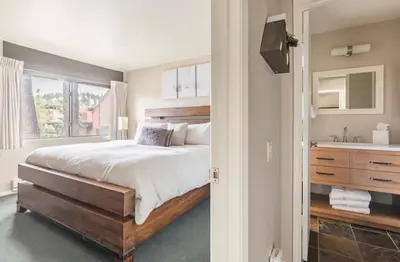a bedroom with a large bed and a sink at Mammoth Ski and Racquet 116 in Mammoth Lakes