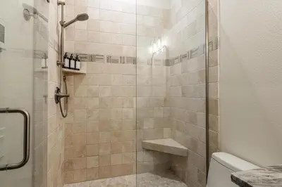 a bathroom with a shower with a sink and a toilet at Timbers 1057 in Mammoth Lakes