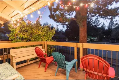 three chairs and a bench on a wooden deck at Villa De Los Pinos 15 in Mammoth Lakes