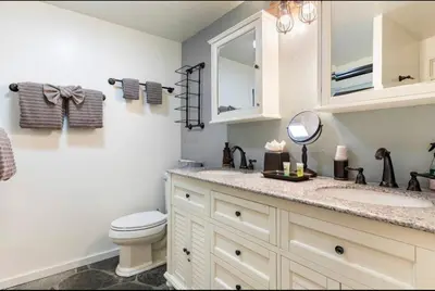a bathroom with a toilet and a sink and a mirror at Villa De Los Pinos 15 in Mammoth Lakes