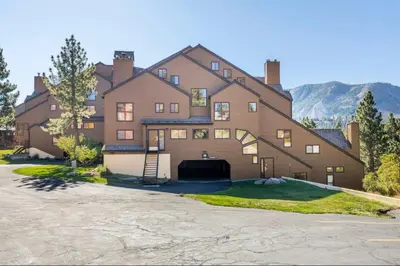 a large brown house with a garage at Aspen Creek 230 in Mammoth Lakes