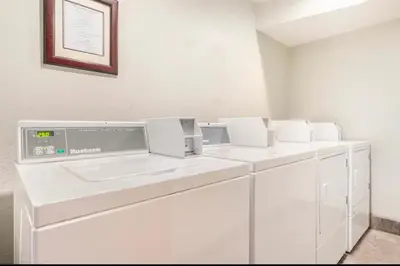 a white laundry room with white washing machines at Viewpoint 151 in Mammoth Lakes