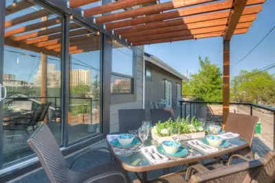 a patio with a table and chairs on a balcony at Stunning View! UNR-Groups-Deck-Reno-Minerva House in Reno