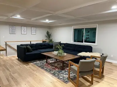 a living room with a blue couch and a table at Peach lane house in Newcastle