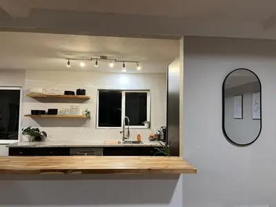 a bathroom with a sink and a mirror at Peach lane house in Newcastle