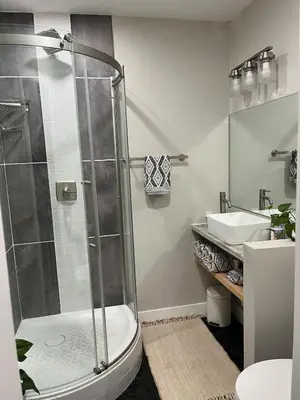 a bathroom with a shower and a sink at Peach lane house in Newcastle
