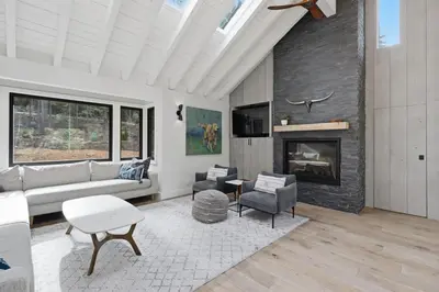 a living room with a couch and a fireplace at Sierra Sanctuary with Hot Tub home in Truckee