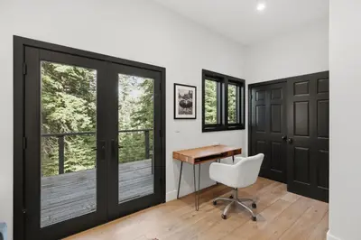 a home office with a desk and sliding glass doors at Sierra Sanctuary with Hot Tub home in Truckee